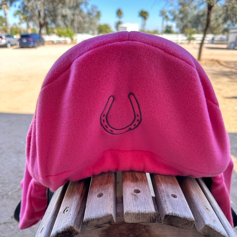 Pink saddle cover with embroidered horseshoe